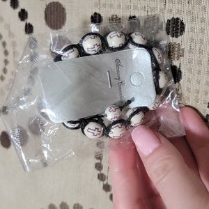 Ivory Adjustable Bead Bracelet with Purple Crosses